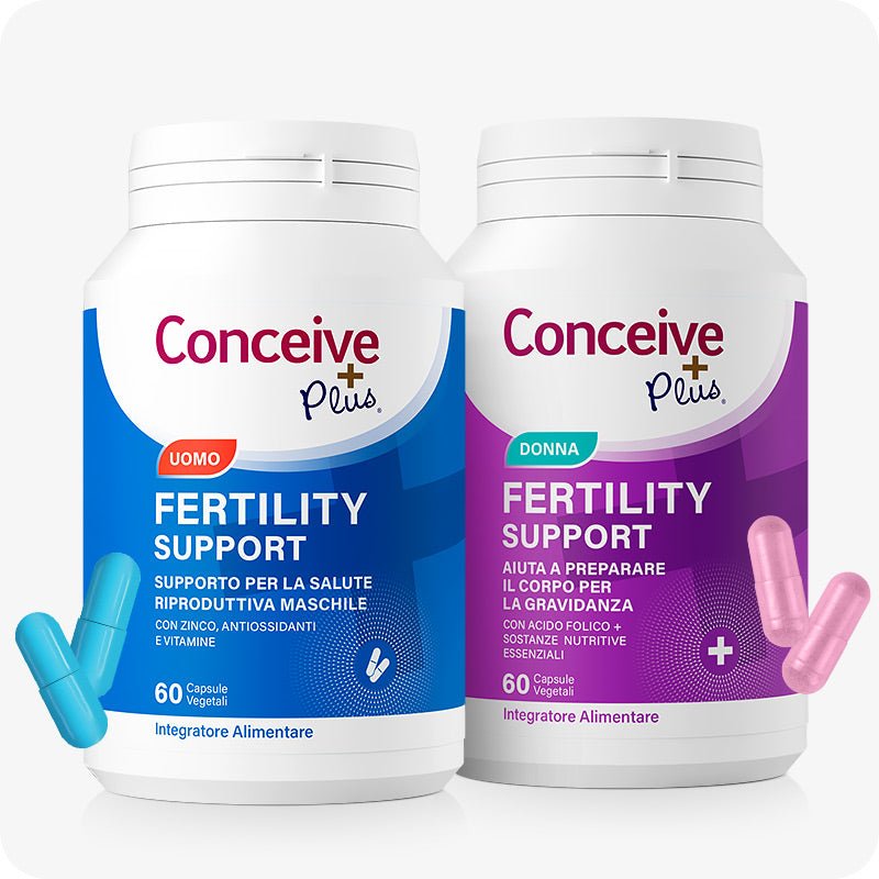 Conceive Plus Couples Bundle Fertility Support (IT) featuring side-by-side bottles of male and female fertility supplements, with blue and pink capsules placed in front, labeled in Italian for reproductive health and pregnancy preparation.