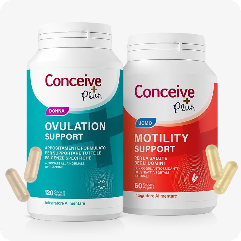 Conceive Plus Fertility Pack Ovulation & Motility (IT) featuring two bottles—Ovulation Support for women with teal labeling and 120 vegetable capsules, and Motility Support for men with red labeling and 60 vegetable capsules—shown with loose capsules on a white background, highlighting Italian-language packaging and gender-specific fertility support.