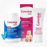 Conceive Plus Men's Combo - Fertility Support + Lubricant (IT) featuring a white bottle of men's fertility support capsules with blue label and two blue capsules, placed beside a pink box and white tube of fertility lubricant featuring Italian text and a baby image, all displayed on a white background.