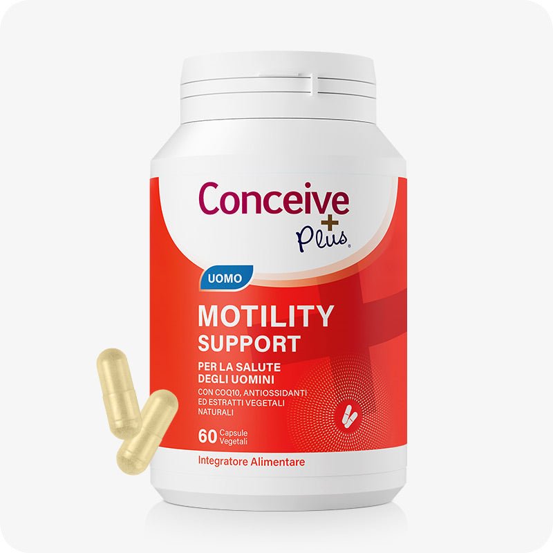 Conceive Plus Motility Support (IT) supplement bottle with bold red and white label, showing “Uomo” tag and 60 vegetable capsules for male fertility; two capsules displayed beside the container on a white background for clarity and accessibility.